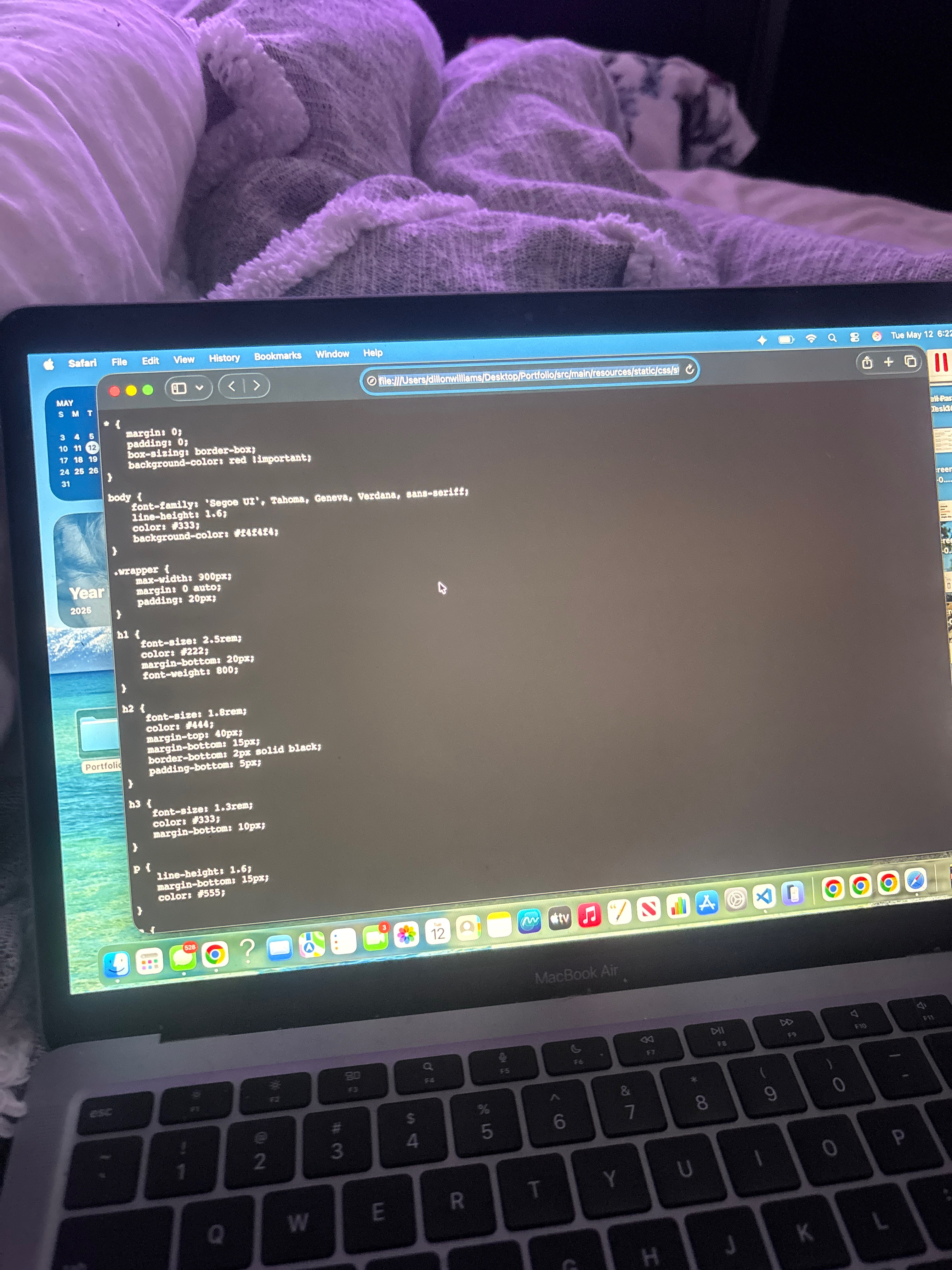 A laptop showing early portfolio code